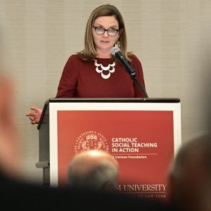 A woman speaks at a podium.