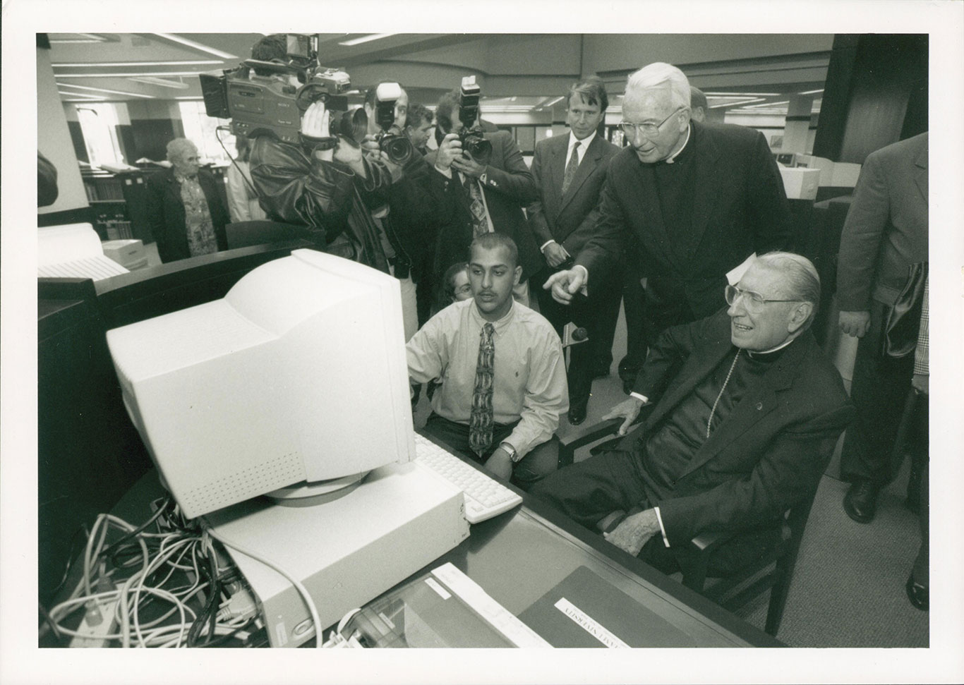 John Cardinal O’Connor, seated at a computer