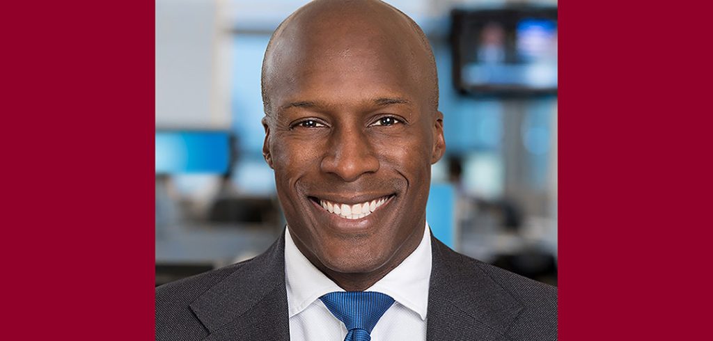 A headshot of Fordham graduate and President's Council member Jason Caldwell in suit and tie