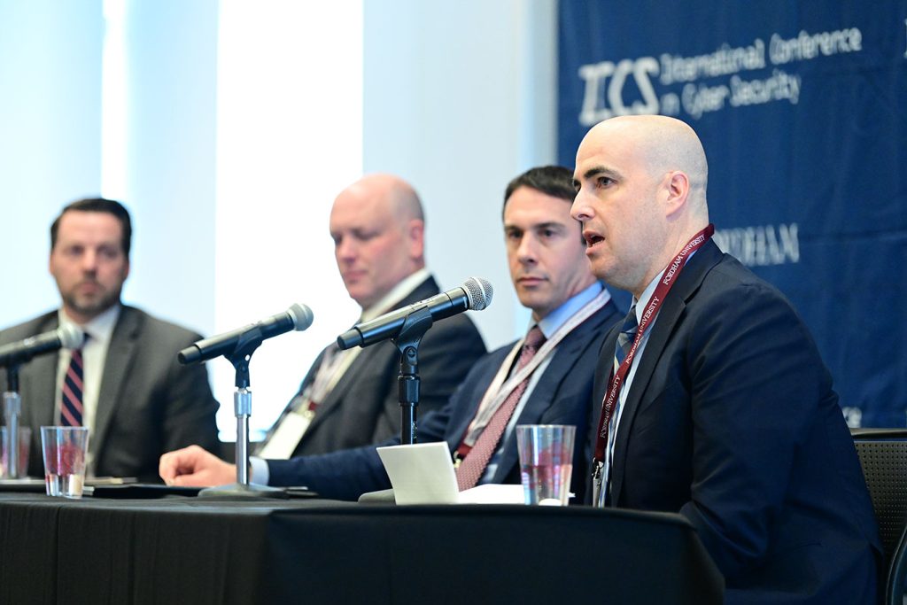 FBI Special agents Steve Fullington,, Scott Norwell, John Reynolds, and Paul F. Roberts Jr. seated at a table.