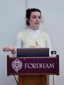 A woman speaks at a podium.