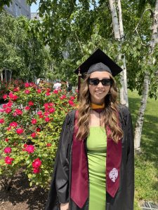 Samantha McCusker standing in front of rose bush