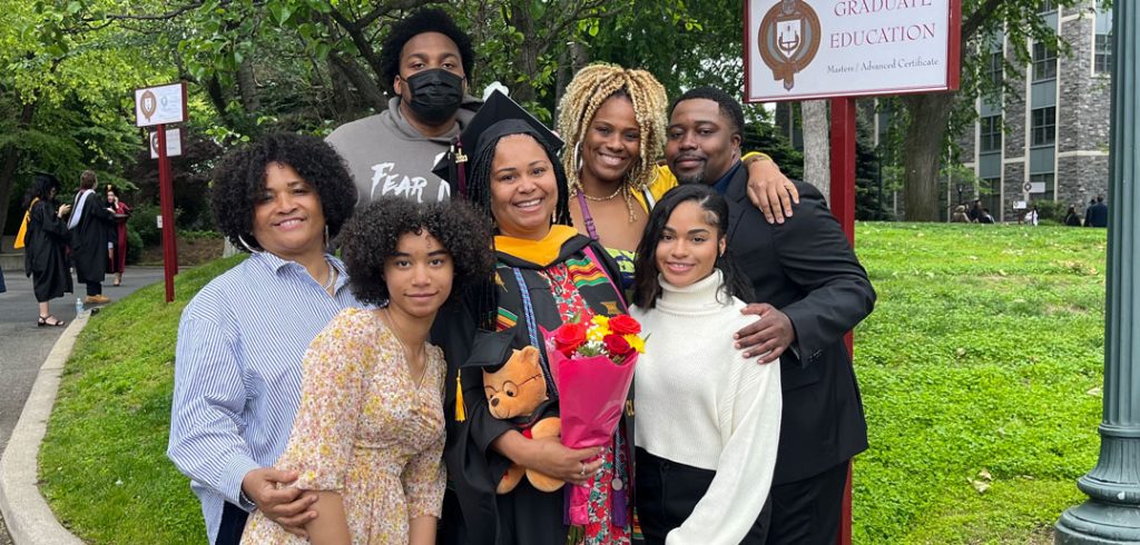 A woman poses with her family