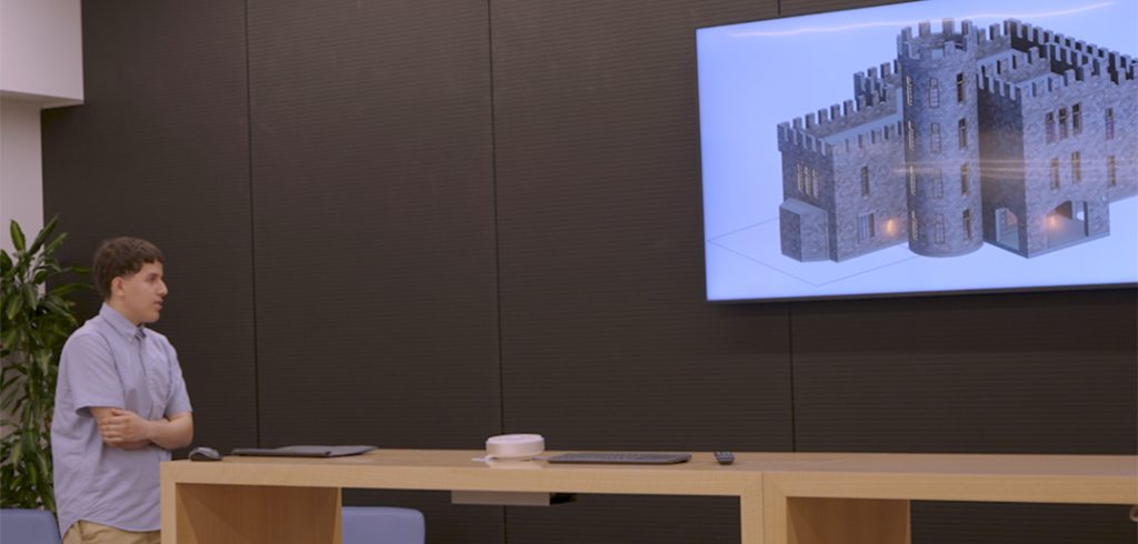 student looking at image of castle on big screen