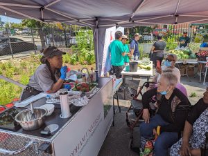 A chef talks to viewers of a cooking demonstration.