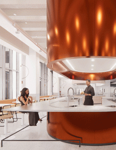 woman sitting at counter with copper hood over food prep area