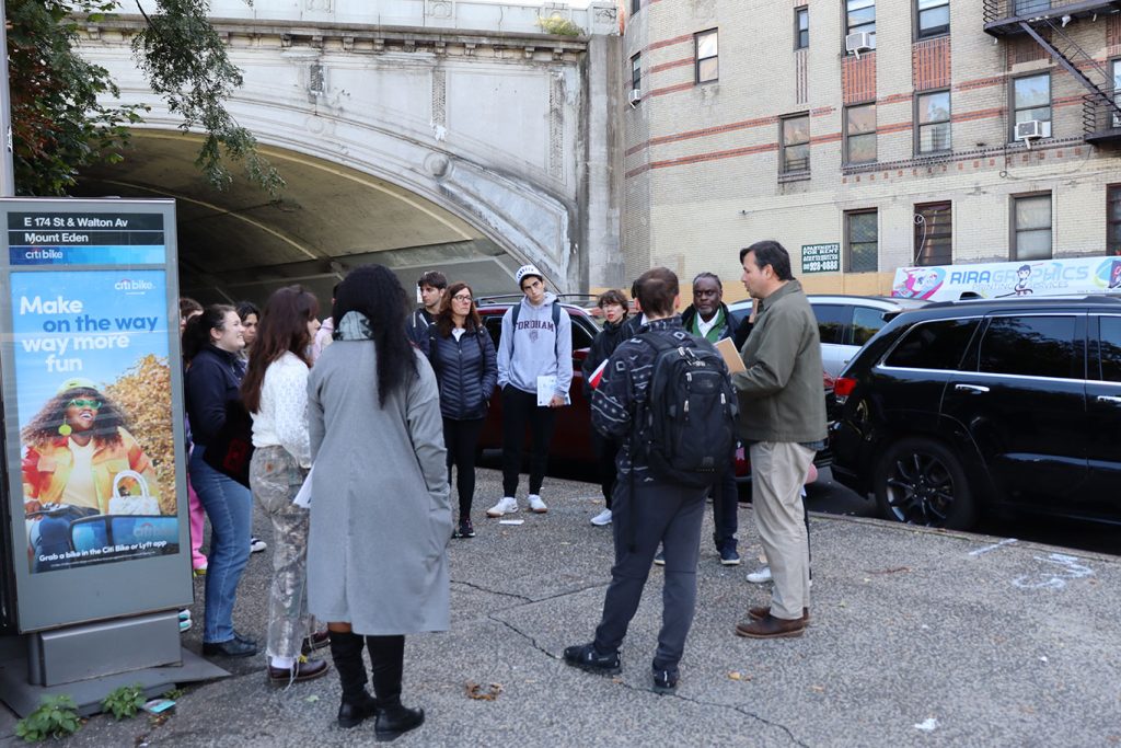 People standing around in a circle on a street 