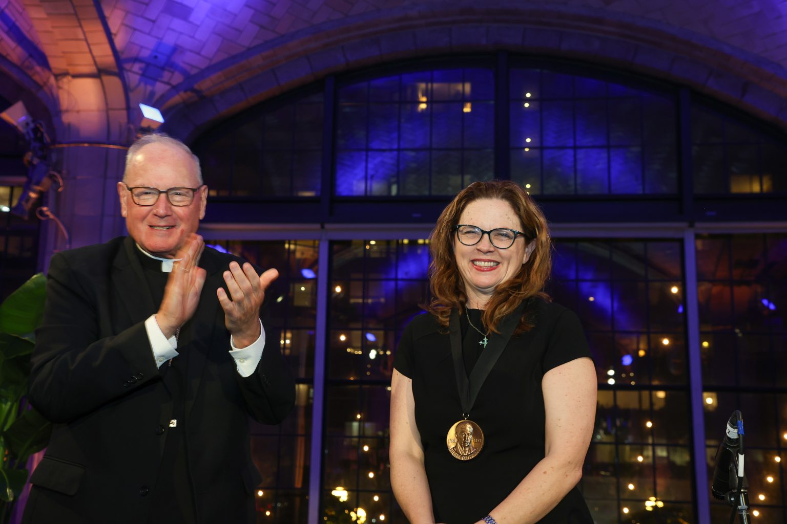 Archbishop of New York Timothy Michael Cardinal Dolan with Fordham President Tania Tetlow. He awarded her the Pierre Toussaint Medallion.