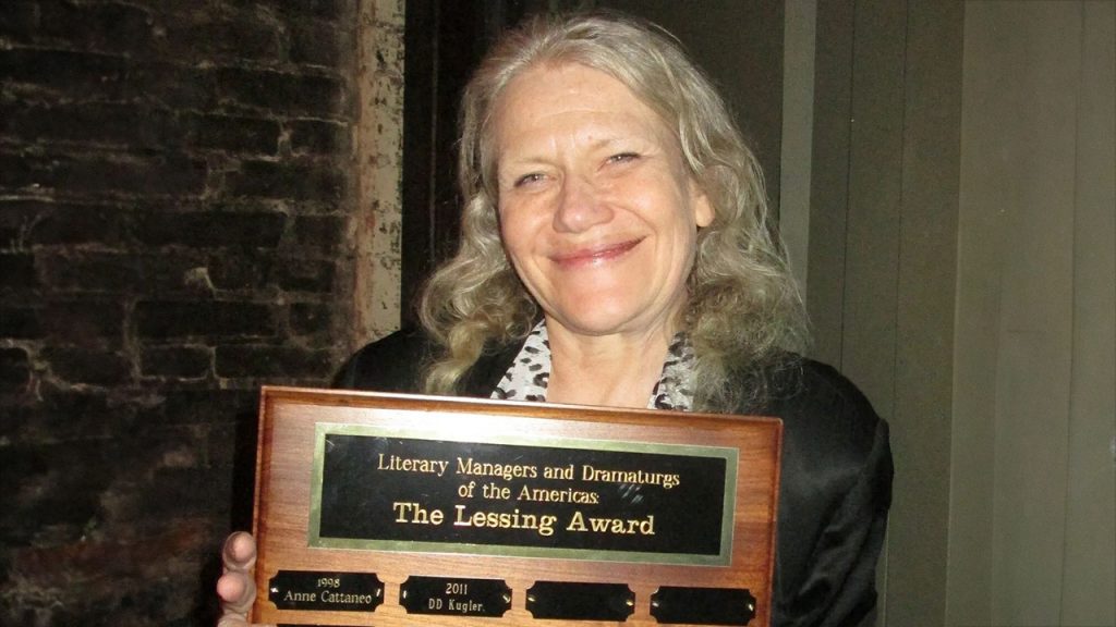 Fordham professor Morgan Jenness in 2015, holding a lifetime achievement award in dramaturgy from the Literary Managers and Dramaturgs of the Americas.