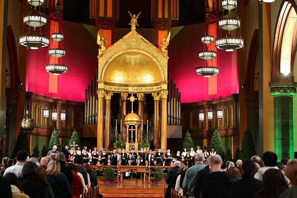 A choir standing in front of an altar.