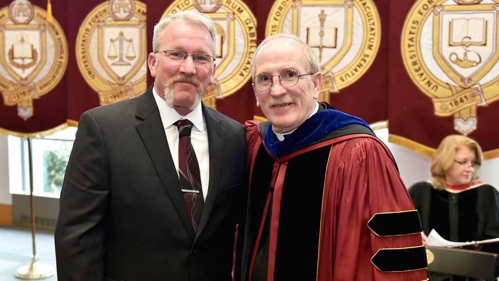 Two men standing together smiling for the camera