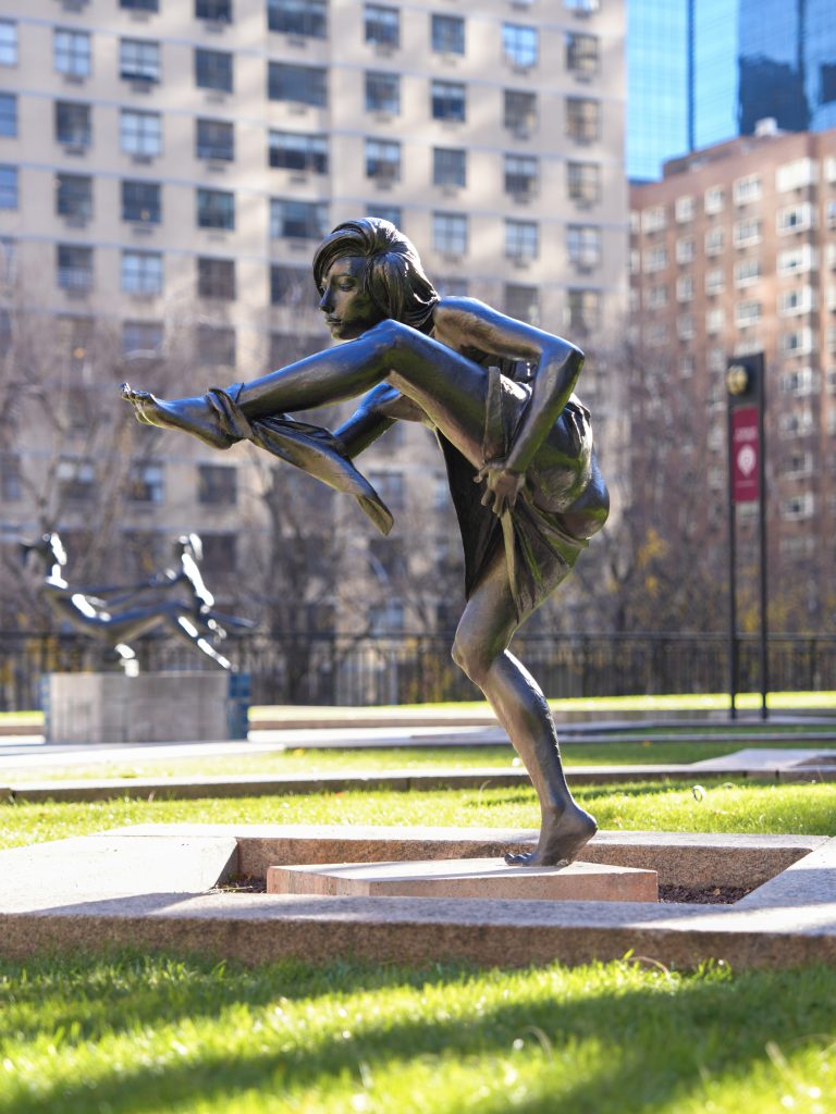 A sculpture of a woman washing her foot, part of Fordham's sculpture walk.