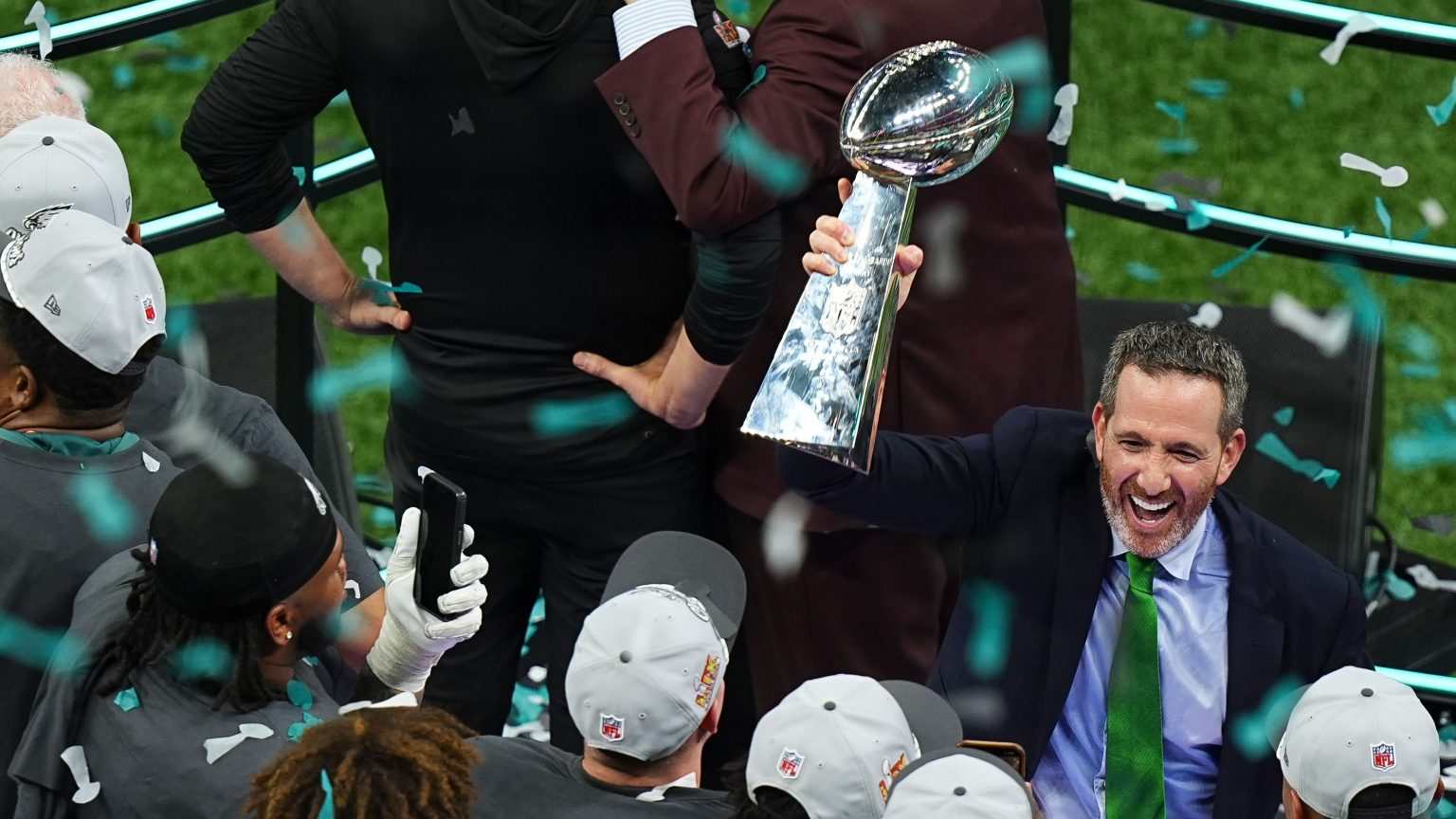 Eagles general manager Howie Roseman lifts the Lombardi trophy after a Super Bowl victory.